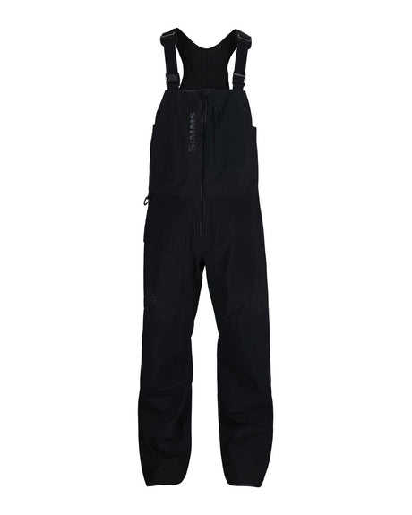 Svarta Simms Pro Dry Bib i GORE-TEX Pro för fiske, med justerbara axelband, dragkedja, bröstficka och förstärkta knän.